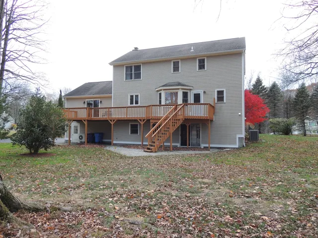 a view of a house with yard and a tree