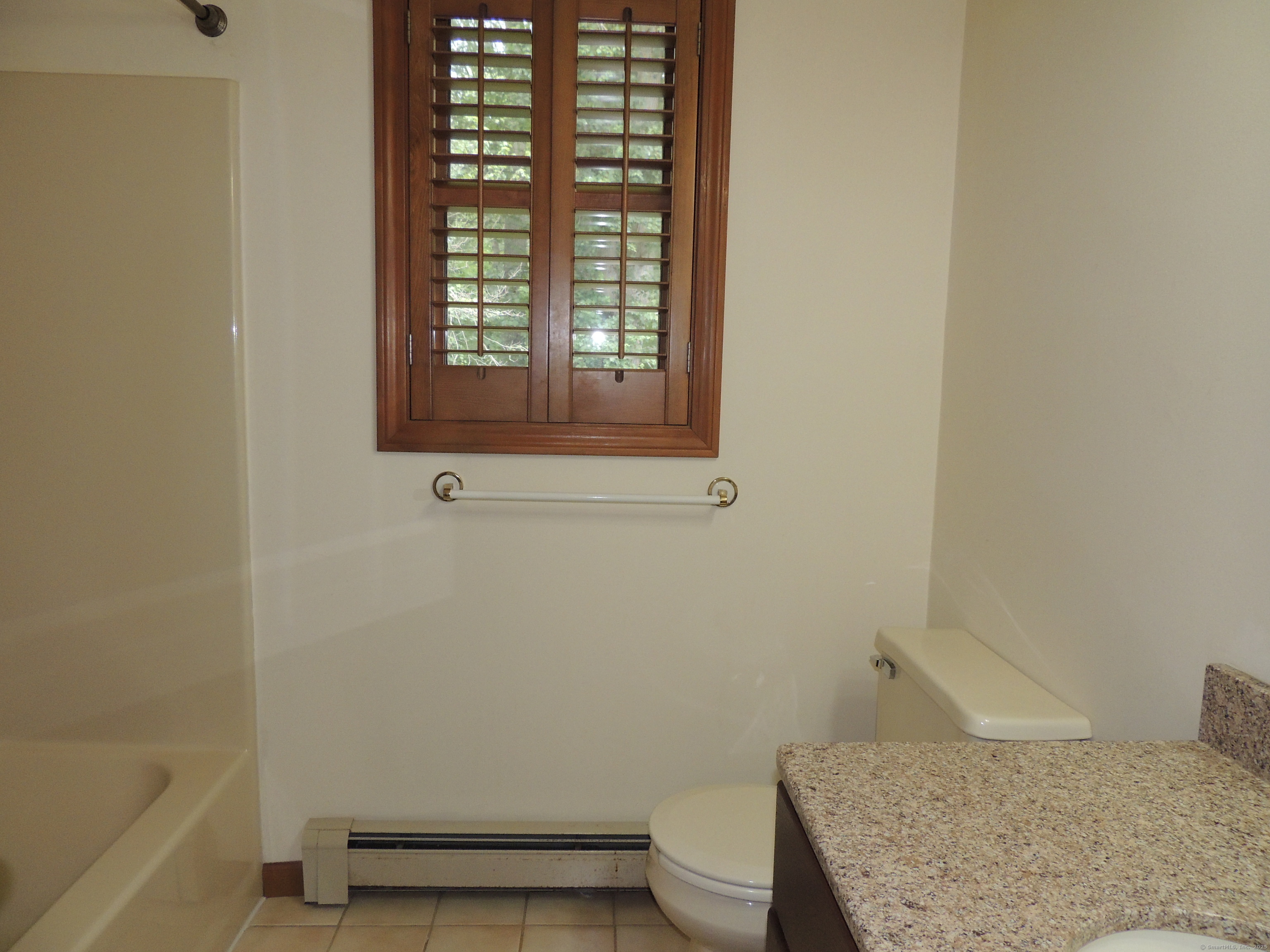12 Cardinal Lane Monroe, CT 06468 - Photo 21 of 38 a bathroom with a granite countertop toilet and a bathtub