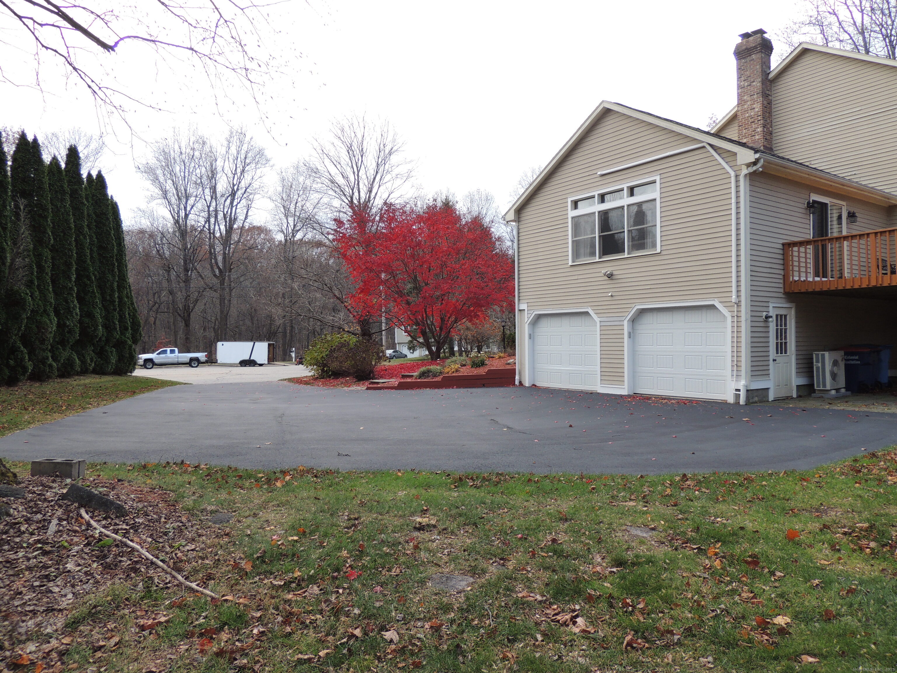 12 Cardinal Lane Monroe, CT 06468 - Photo 37 of 38 a front view of a house with a yard and garage