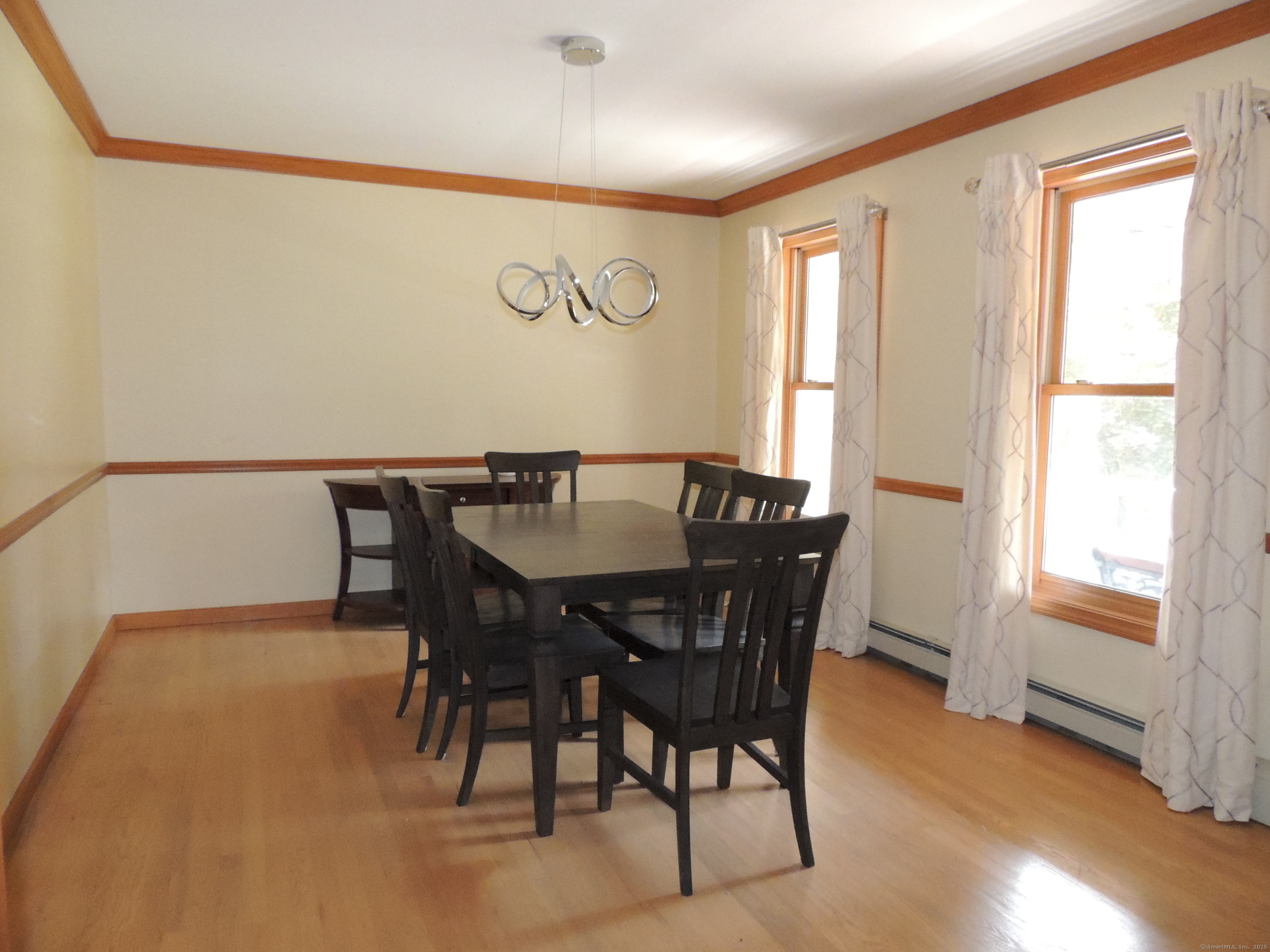 12 Cardinal Lane Monroe, CT 06468 - Photo 8 of 38 a view of a dining room with furniture and wooden floor