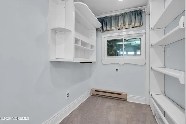 a view of an empty room with chandelier