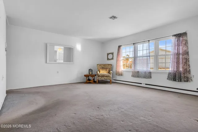 a big room with a fireplace and windows