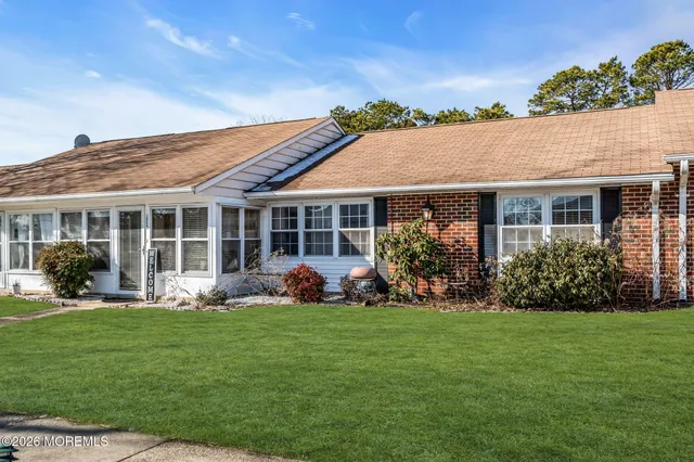 a front view of a house with garden and porch