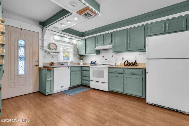 a kitchen with a refrigerator a sink dishwasher and a refrigerator