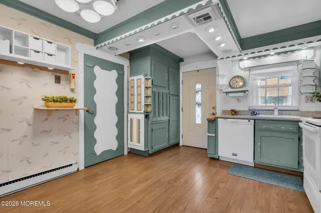 a view of a kitchen with a sink and a refrigerator