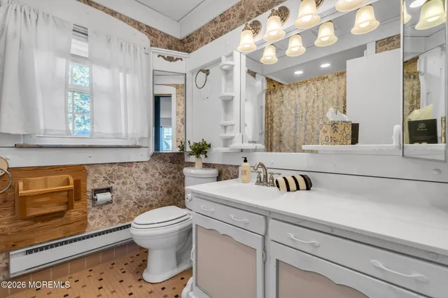 a bathroom with a sink a toilet and mirror