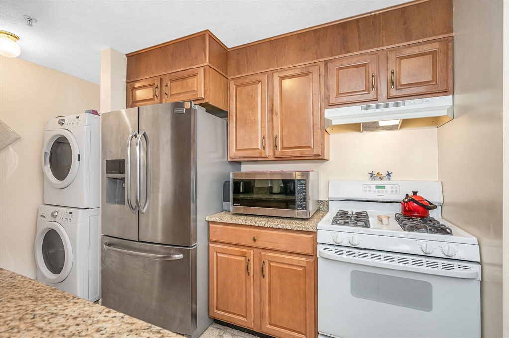 39 Broadway, Unit 305 Malden, MA 02148 - Photo 7 of 36 a kitchen with white cabinets and white appliances