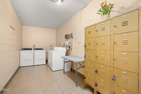 a utility room with cabinets and washer dryer