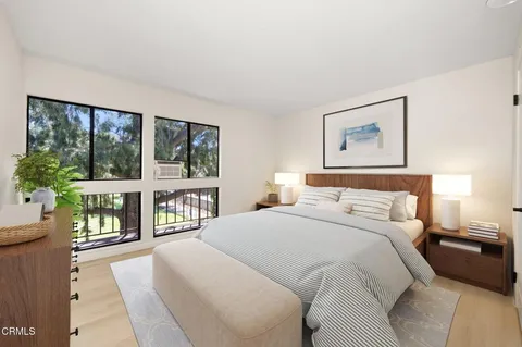 a bedroom with a large bed and a large window