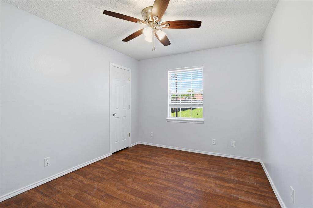 1974 County Road Powderly, TX 75473 - Photo 22 of 28 an empty room with a window and a fan