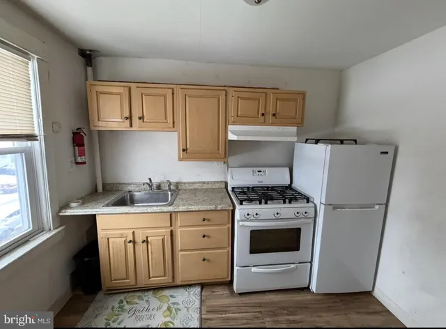 a kitchen with a stove top oven sink and cabinets