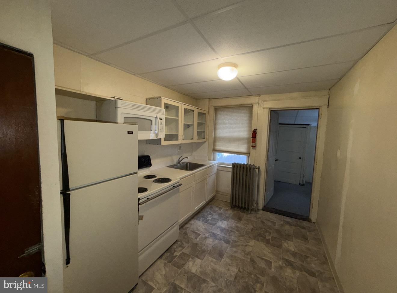 205 Marshall Avenue Darby, PA 19023 - Photo 4 of 14 a kitchen with refrigerator a stove a microwave and a refrigerator