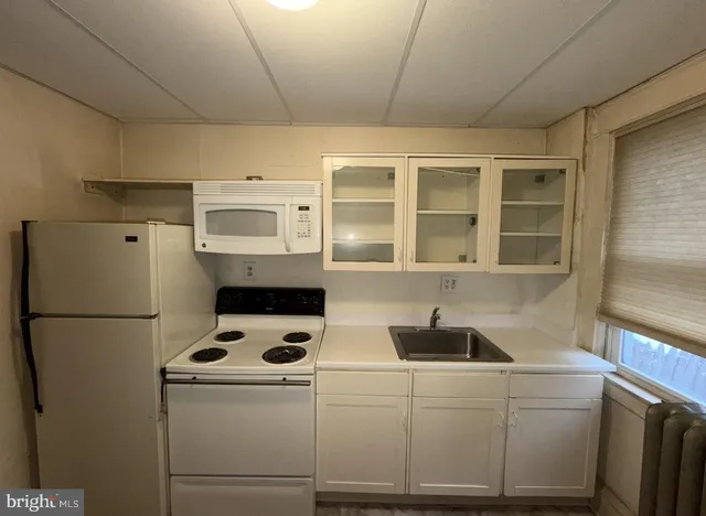 a white refrigerator freezer sitting inside of a kitchen