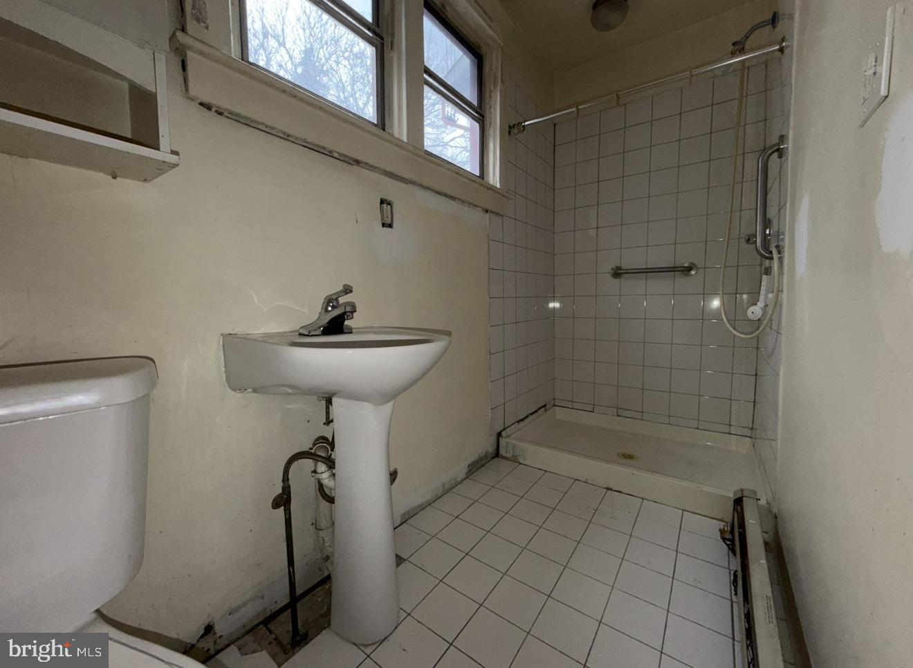 205 Marshall Avenue Darby, PA 19023 - Photo 7 of 14 a bathroom with a sink a mirror and a shower