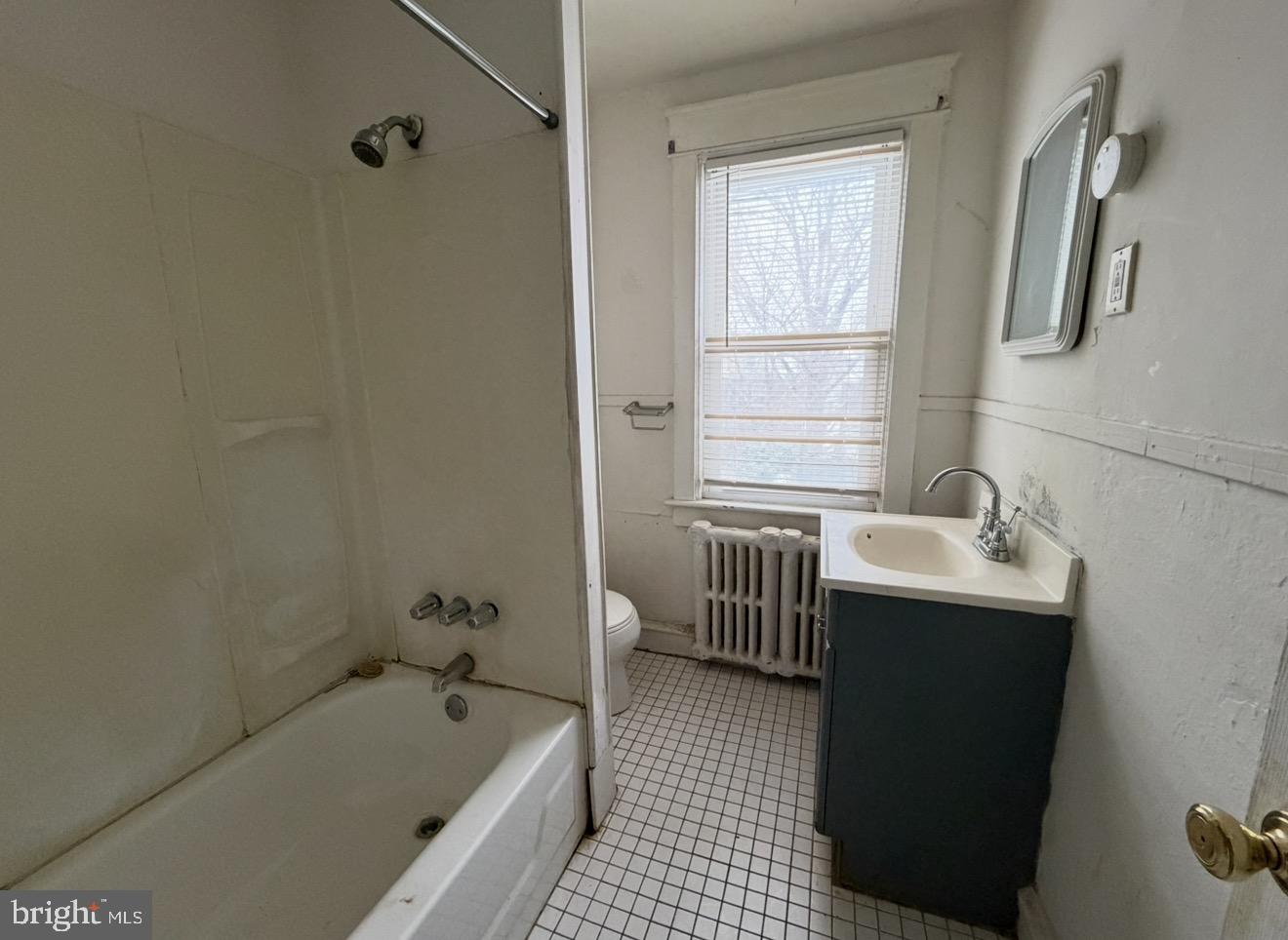 205 Marshall Avenue Darby, PA 19023 - Photo 8 of 14 a bathroom with a tub sink and mirror