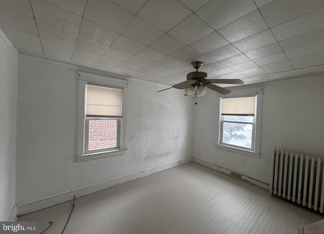 205 Marshall Avenue Darby, PA 19023 - Photo 10 of 14 an empty room with a window and a ceiling fan