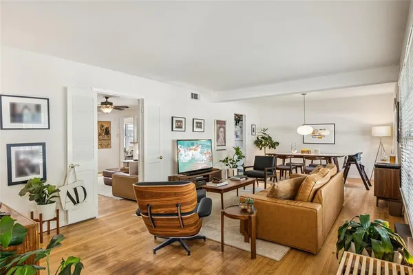 a living room with furniture and wooden floor