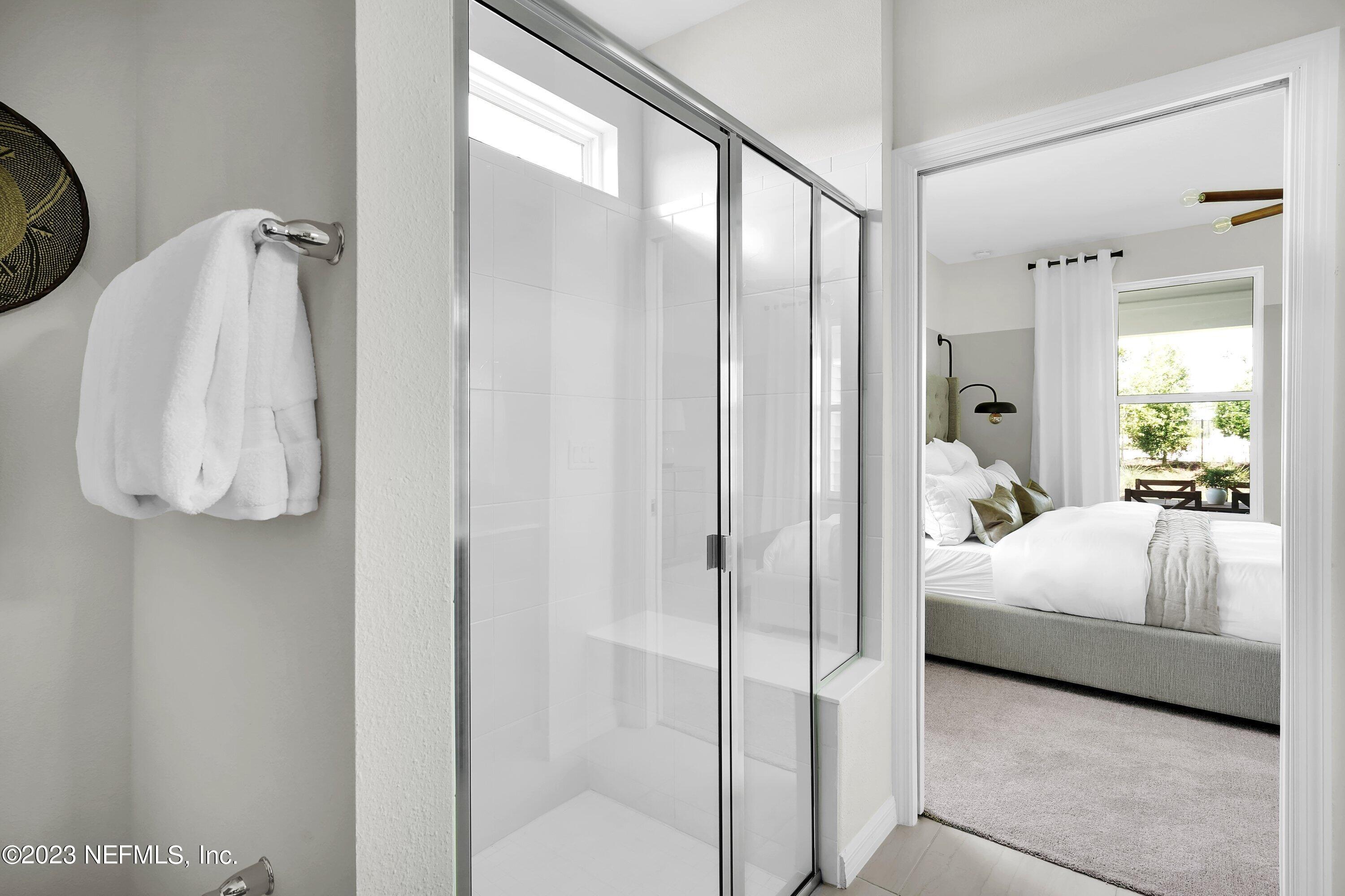 597 Continuum Loop Yulee, FL 32097 - Photo 11 of 23 a bedroom with a bed and a mirror