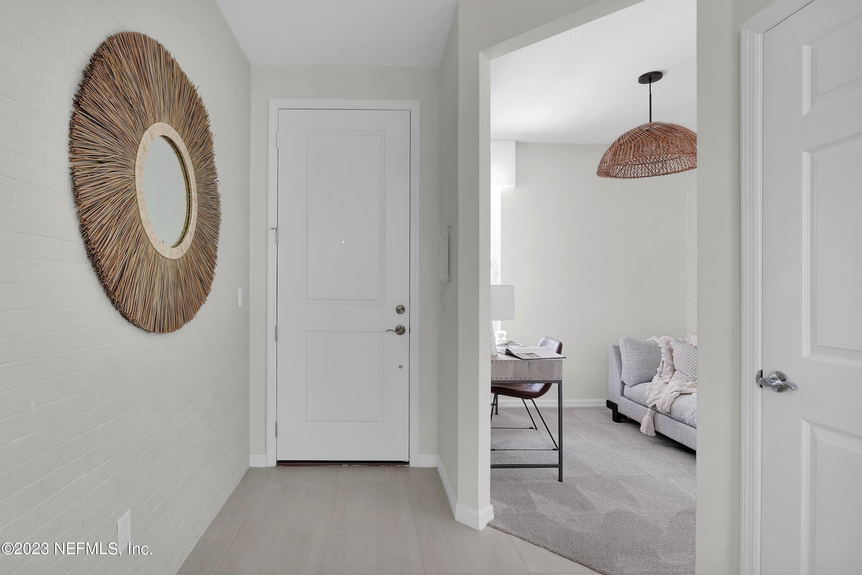 597 Continuum Loop Yulee, FL 32097 - Photo 3 of 23 a room with a walk in closet and a chair