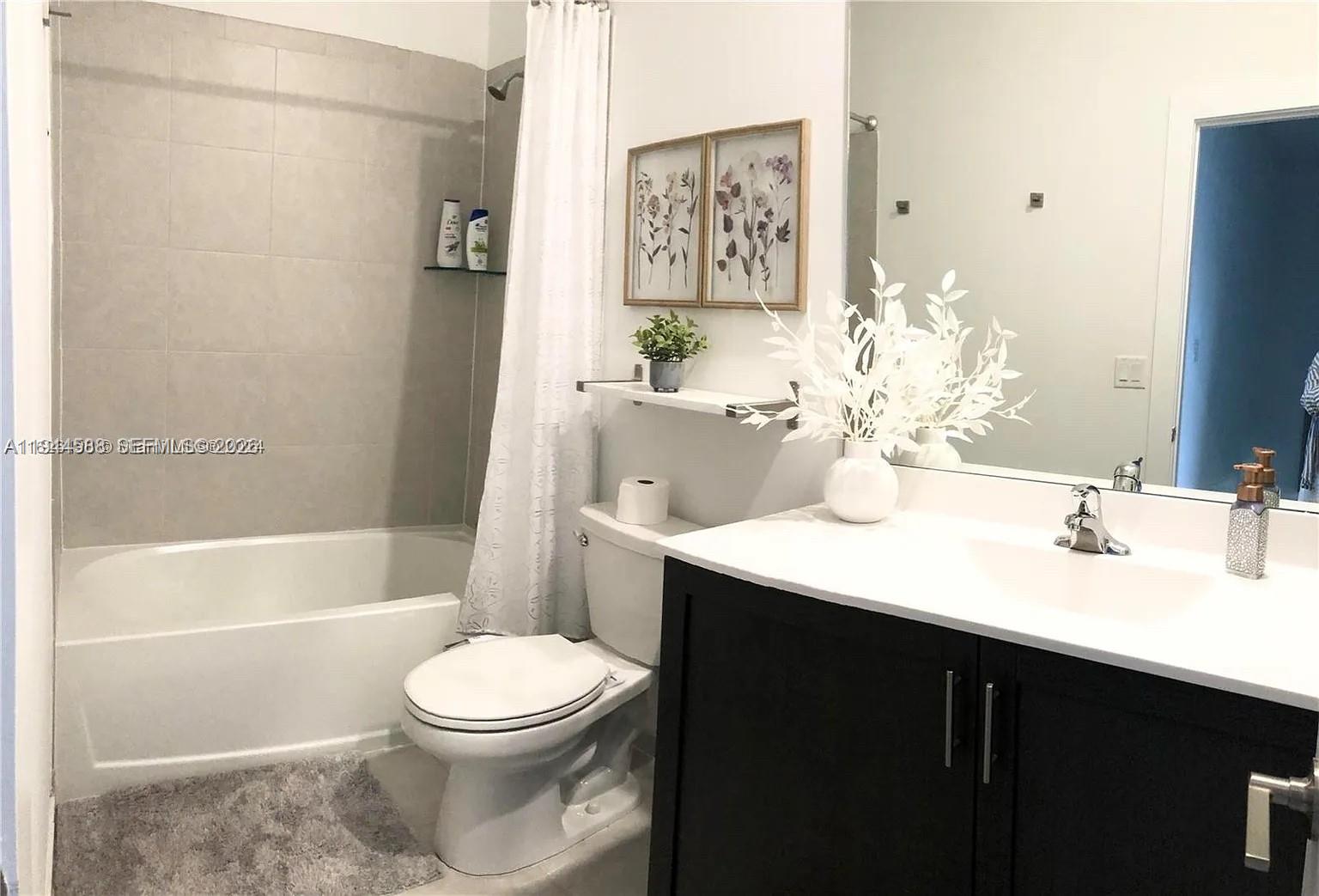 10162 Southwest 228th Terrace Miami, FL 33190 - Photo 18 of 20 a bathroom with a sink a toilet and shower