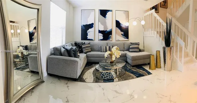 a living room with furniture and a large mirror