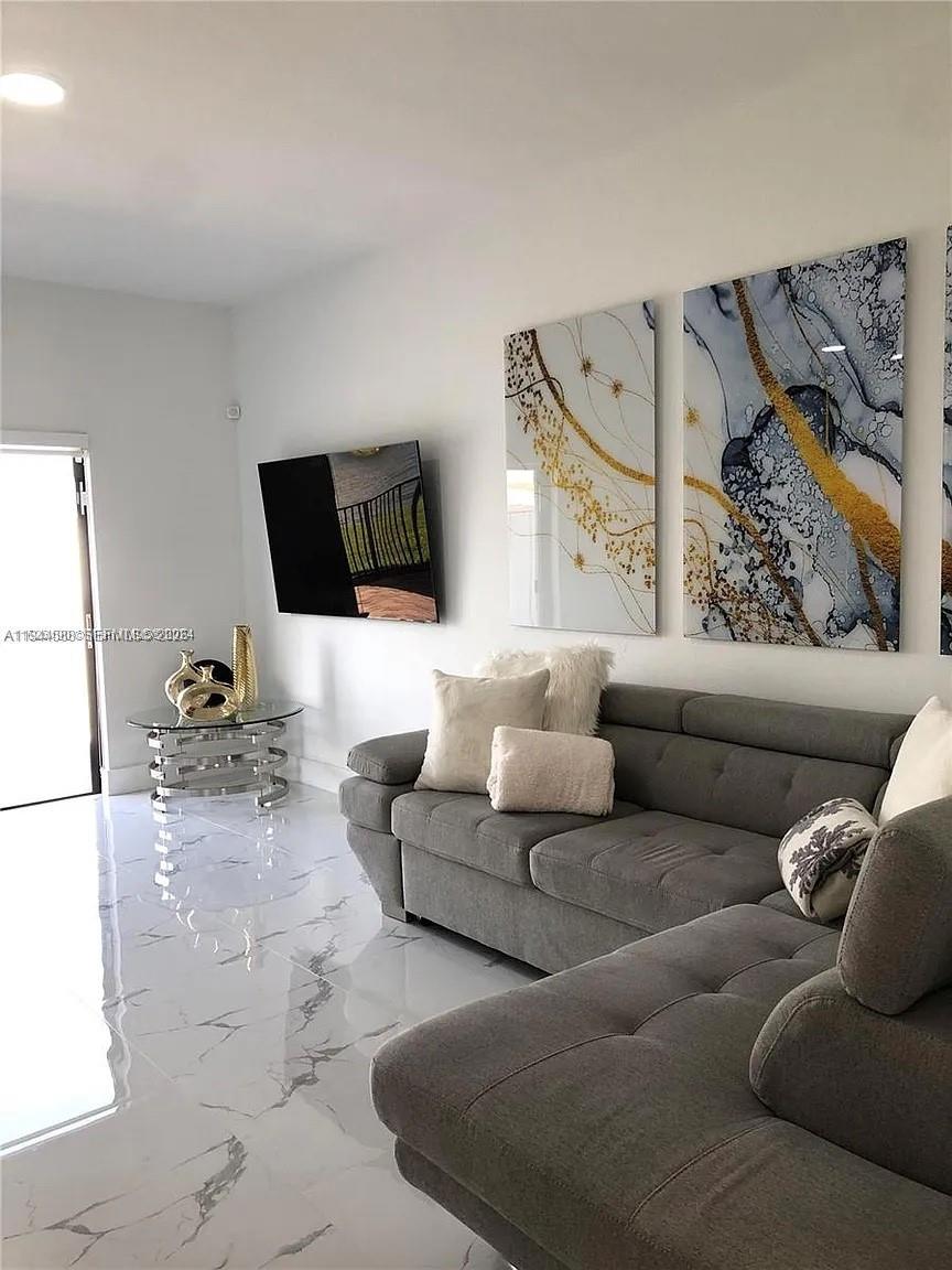 10162 Southwest 228th Terrace Miami, FL 33190 - Photo 9 of 20 a living room with furniture and a flat screen tv