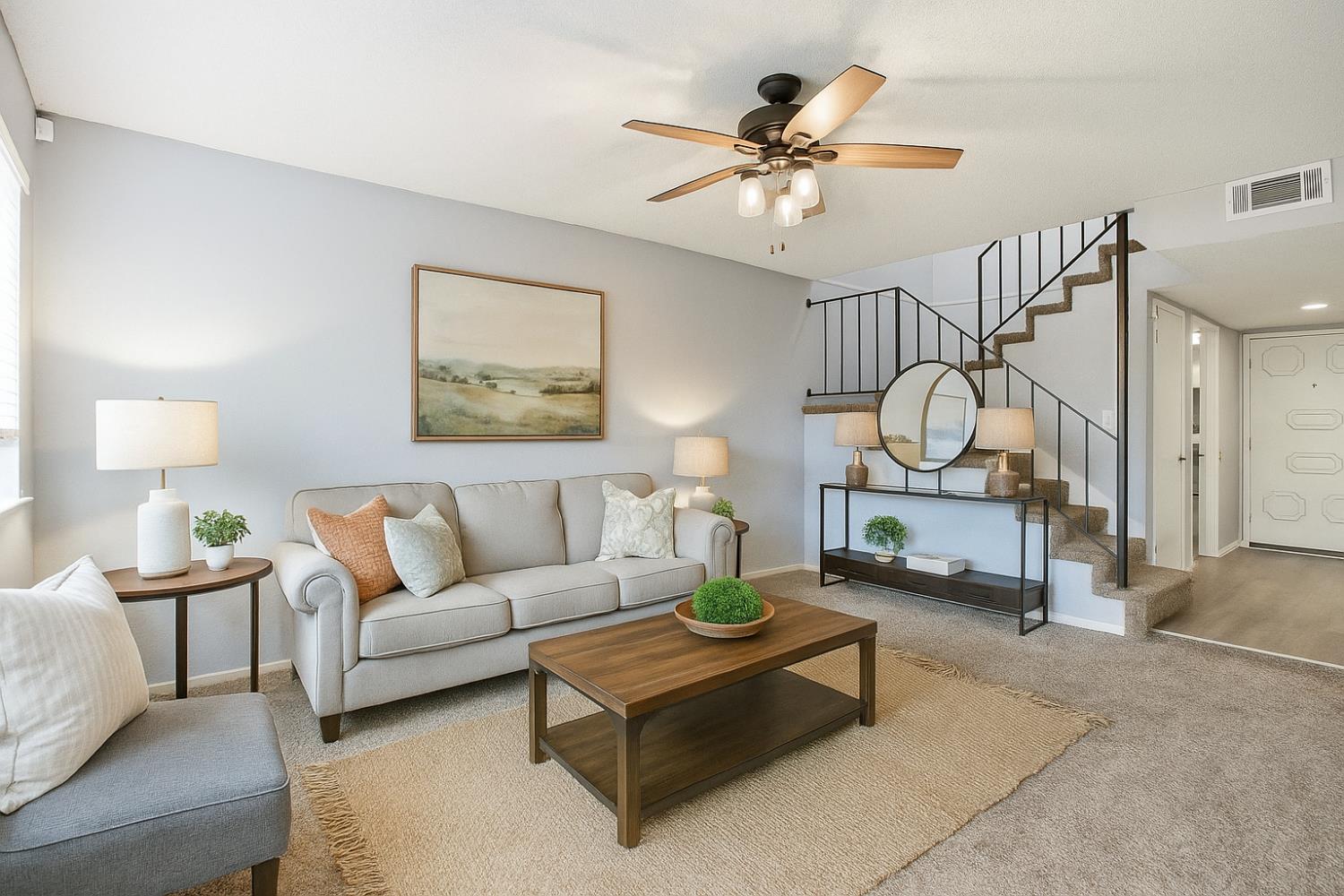 a living room with furniture a rug and a chandelier