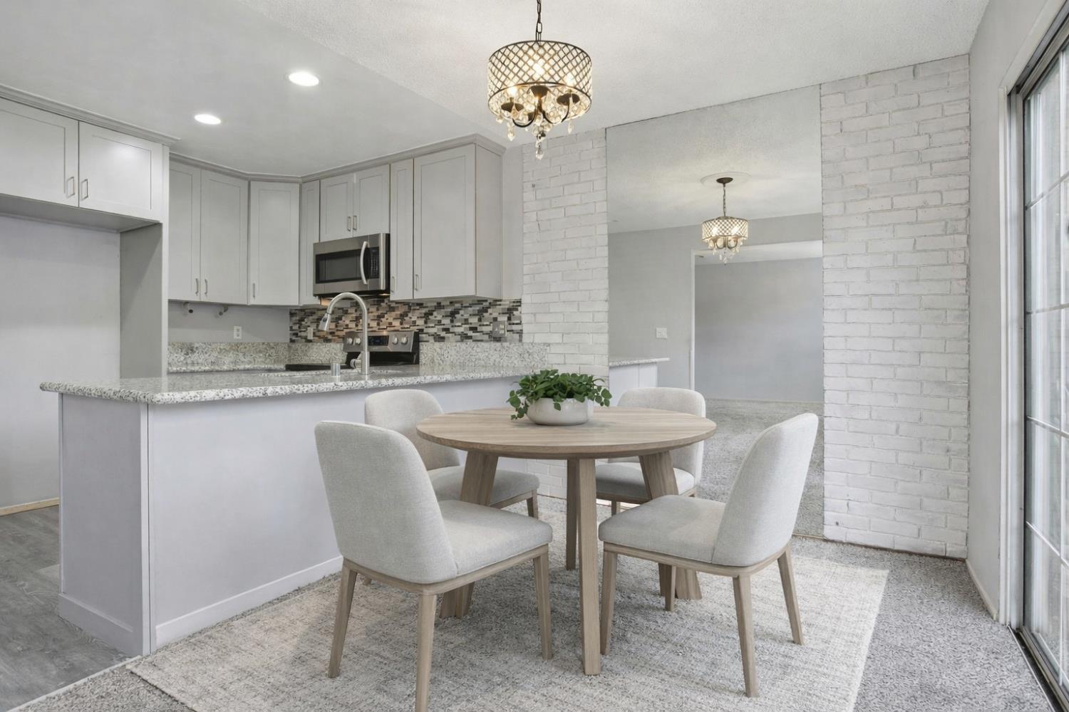 5805 Muldrow Road Sacramento, CA 95841 - Photo 11 of 28 a view of a dining room with furniture and chandelier