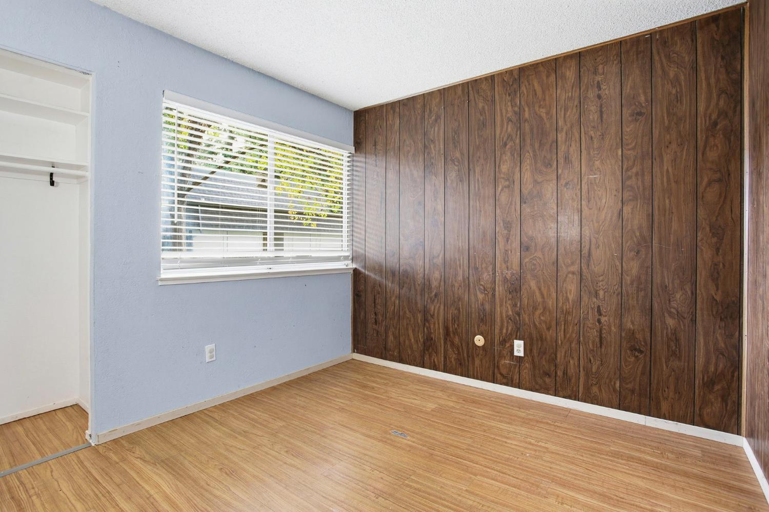 5805 Muldrow Road Sacramento, CA 95841 - Photo 16 of 28 a view of an empty room with wooden floor and a window