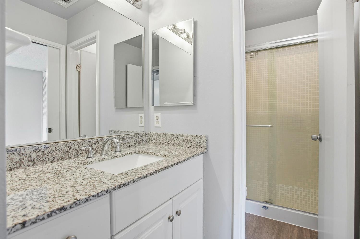 5805 Muldrow Road Sacramento, CA 95841 - Photo 21 of 28 a bathroom with a granite countertop sink and a mirror