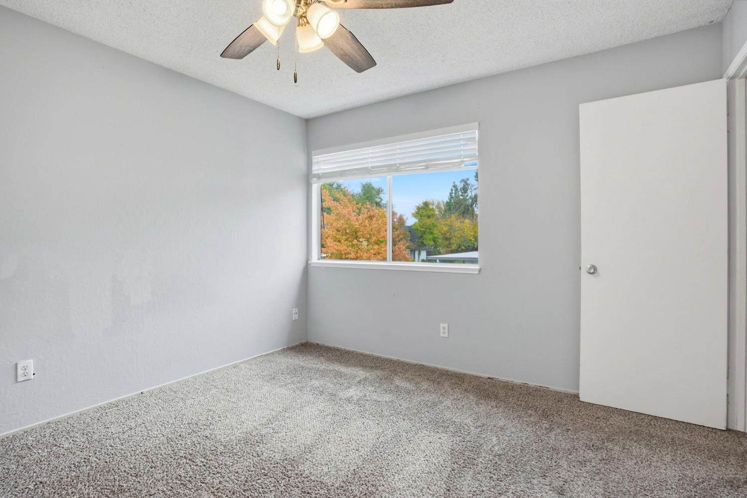 5805 Muldrow Road Sacramento, CA 95841 - Photo 22 of 28 an empty room with a window and a ceiling fan