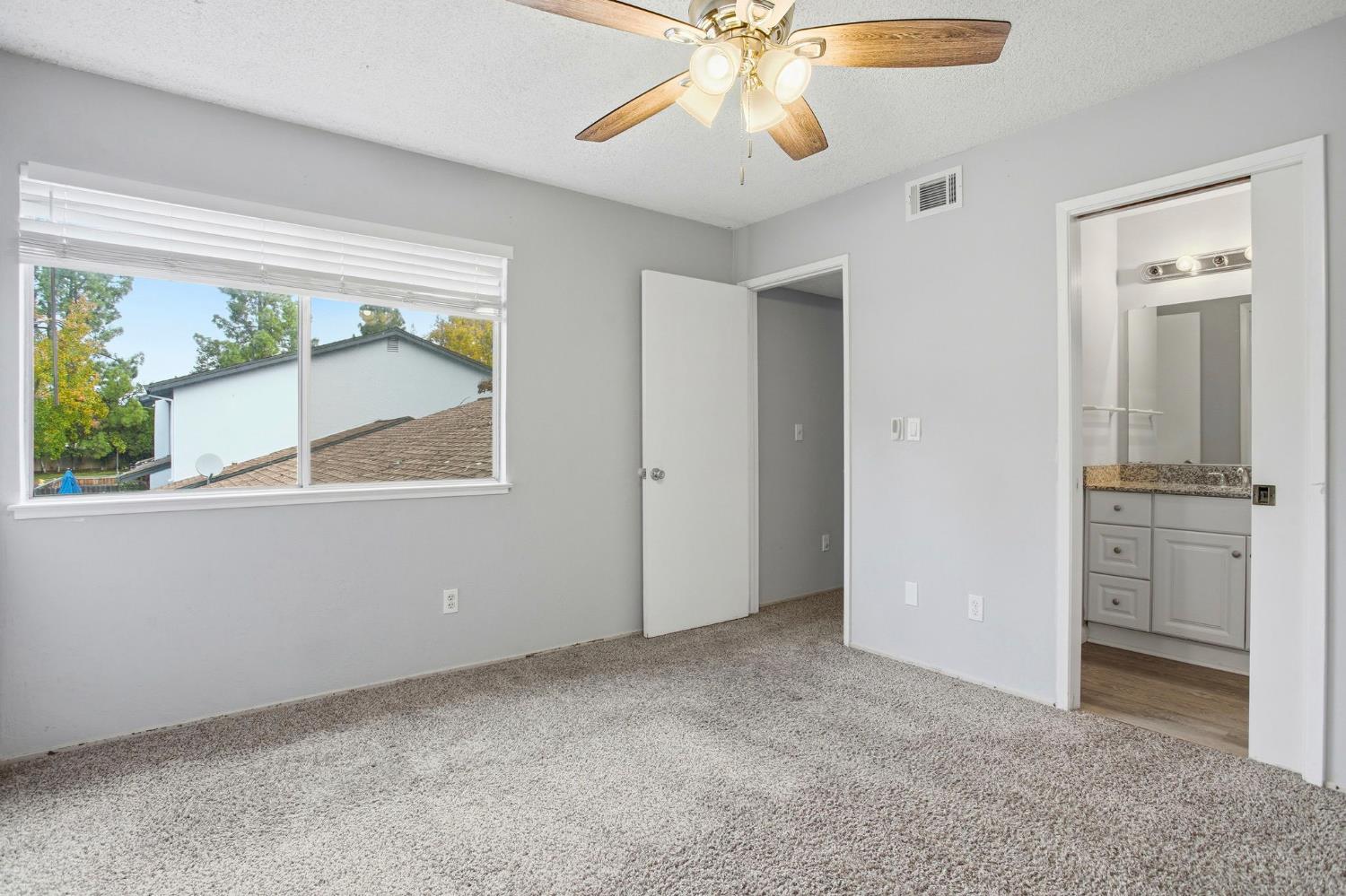 5805 Muldrow Road Sacramento, CA 95841 - Photo 23 of 28 an empty room with windows and fan