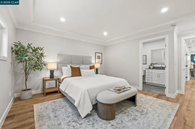 a spacious bedroom with a bed and a potted plant