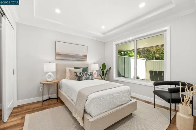 a bedroom with a bed and a large window