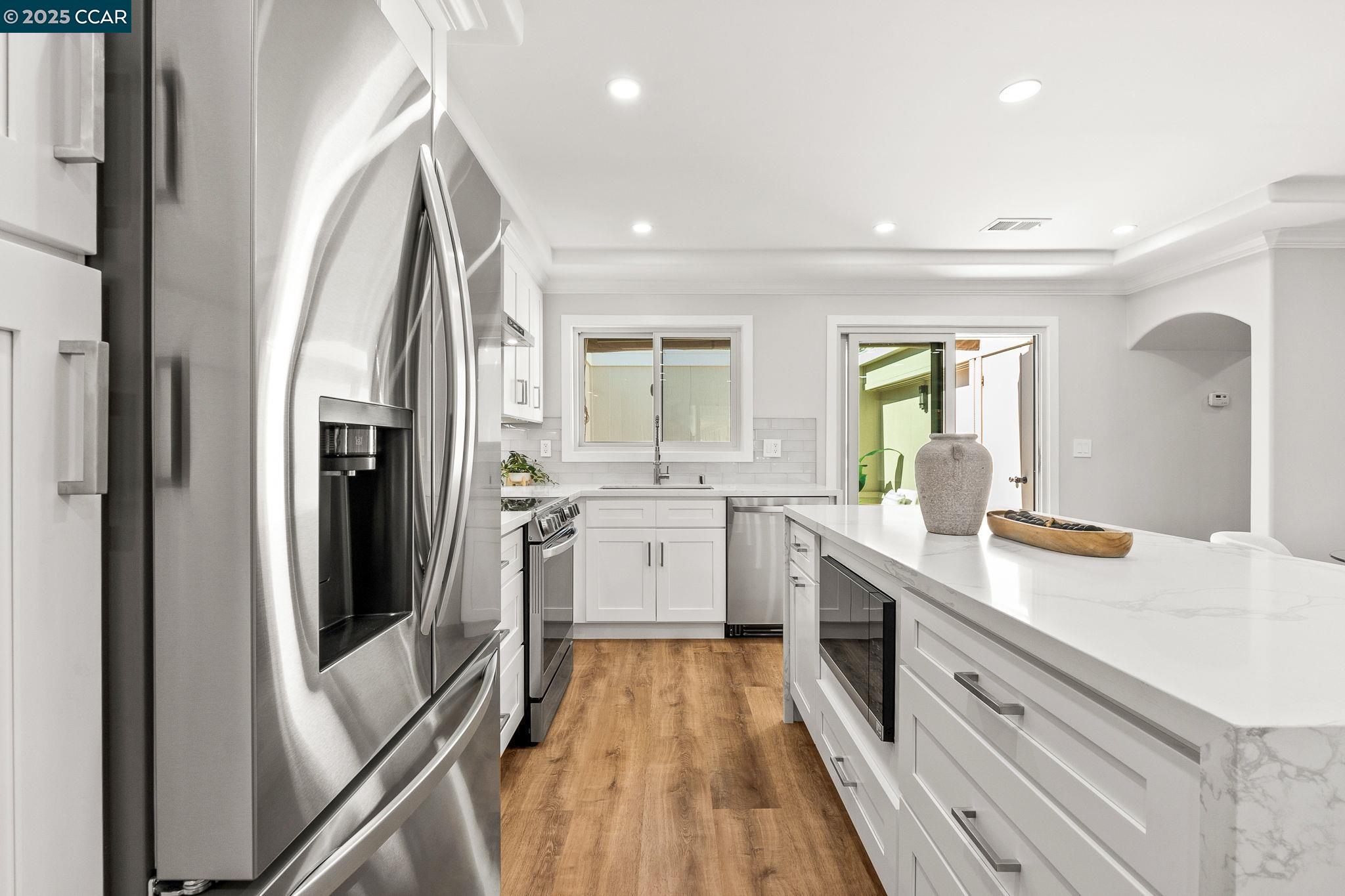 2300 Pine Knoll Drive, Unit 1 Walnut Creek, CA 94595 - Photo 22 of 46 a kitchen with a sink refrigerator and cabinets