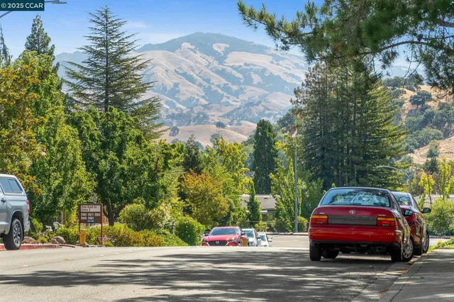 a front view of a house with car parked