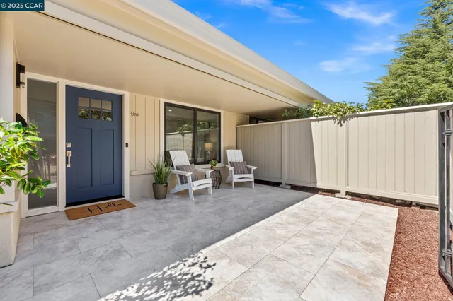 a view of backyard with outdoor seating and stairs