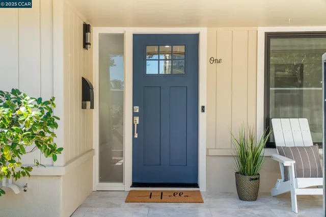 a view of a hallway with wooden floor and a potted plant