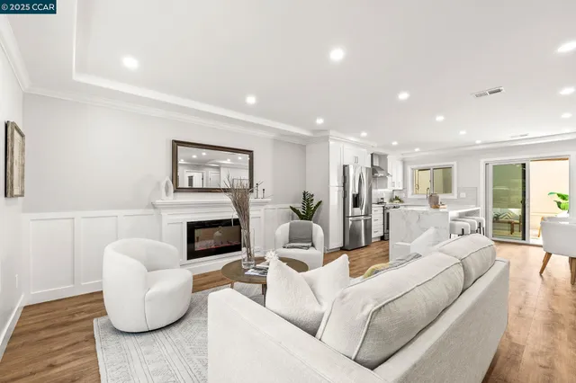 a living room with furniture a fireplace and a window