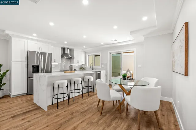 a dining room with furniture and wooden floor