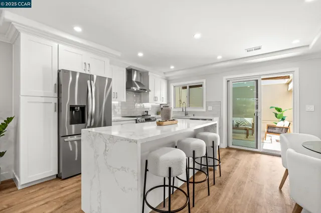 a kitchen with refrigerator and furniture
