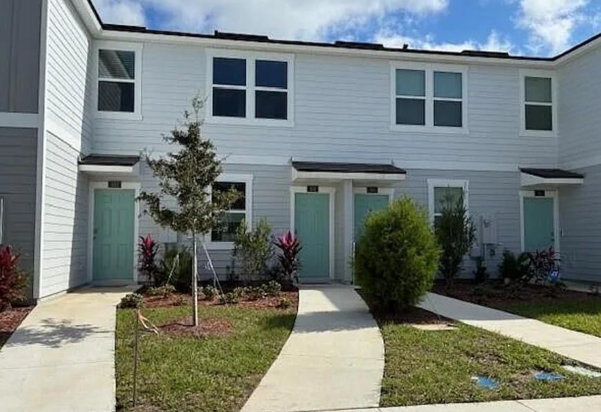 106 Hidden Mdws Road St. Augustine, FL 32095 - Photo 1 of 1 a front view of a house with garden