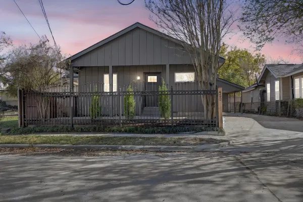 a view of a house with a yard and garage