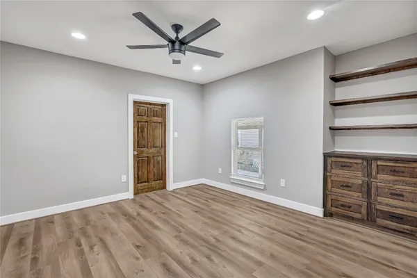 a kitchen with stainless steel appliances granite countertop a sink and cabinets with wooden floor