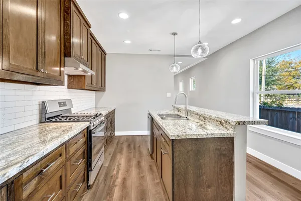 a bathroom with a granite countertop toilet a sink and a bathtub