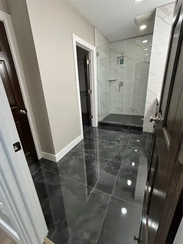 a spacious bathroom with a bathtub sink mirror and toilet