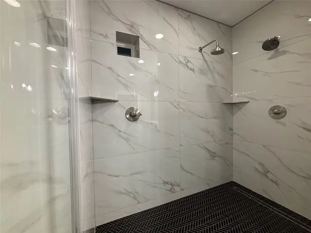 a bathroom with a glass shower door and a sink