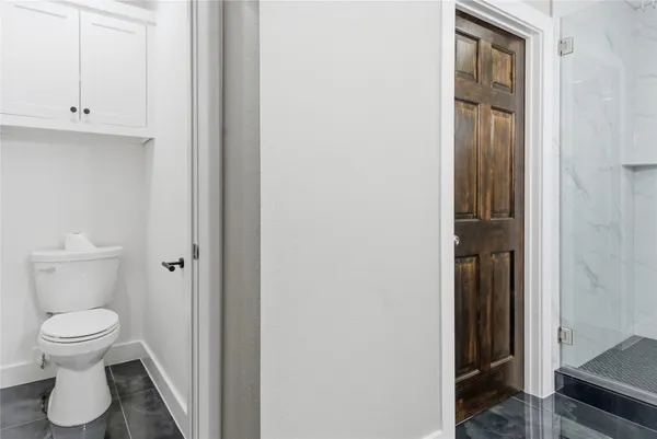 a bathroom with a glass shower door and a sink