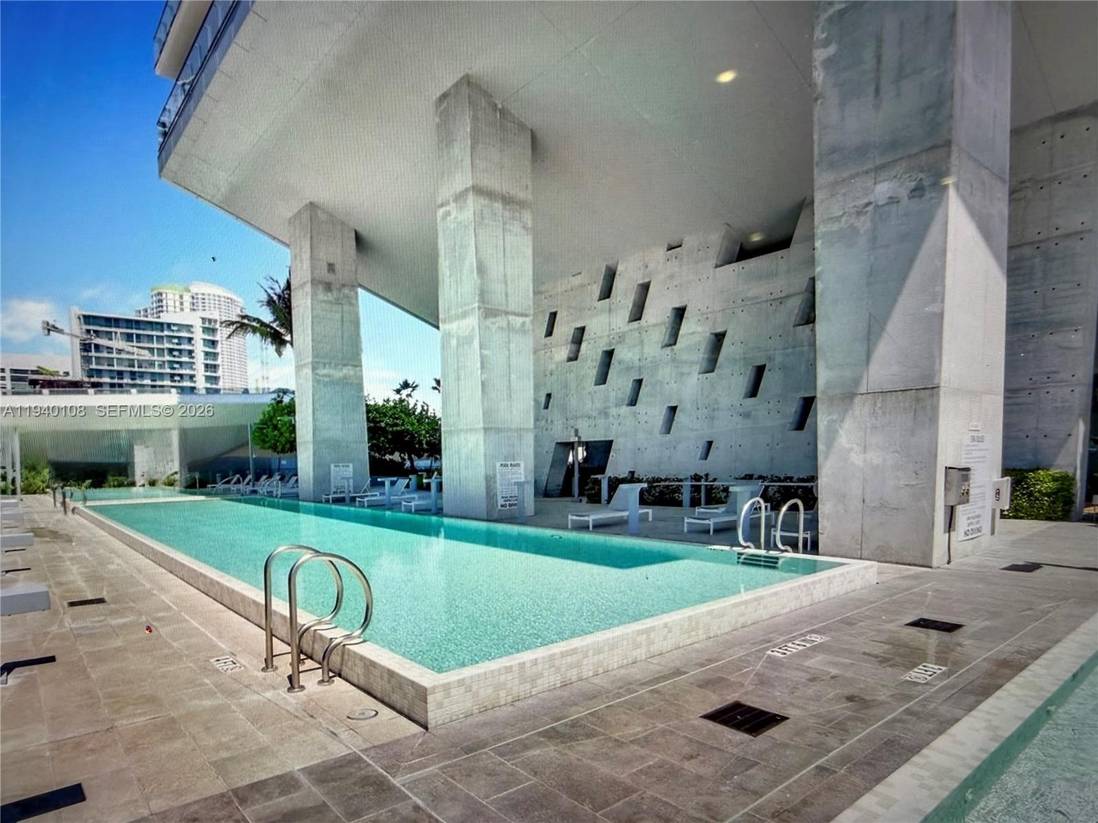 68 Southeast 6th Street, Unit 3708 Miami, FL 33131 - Photo 17 of 17 a view of a swimming pool with a patio