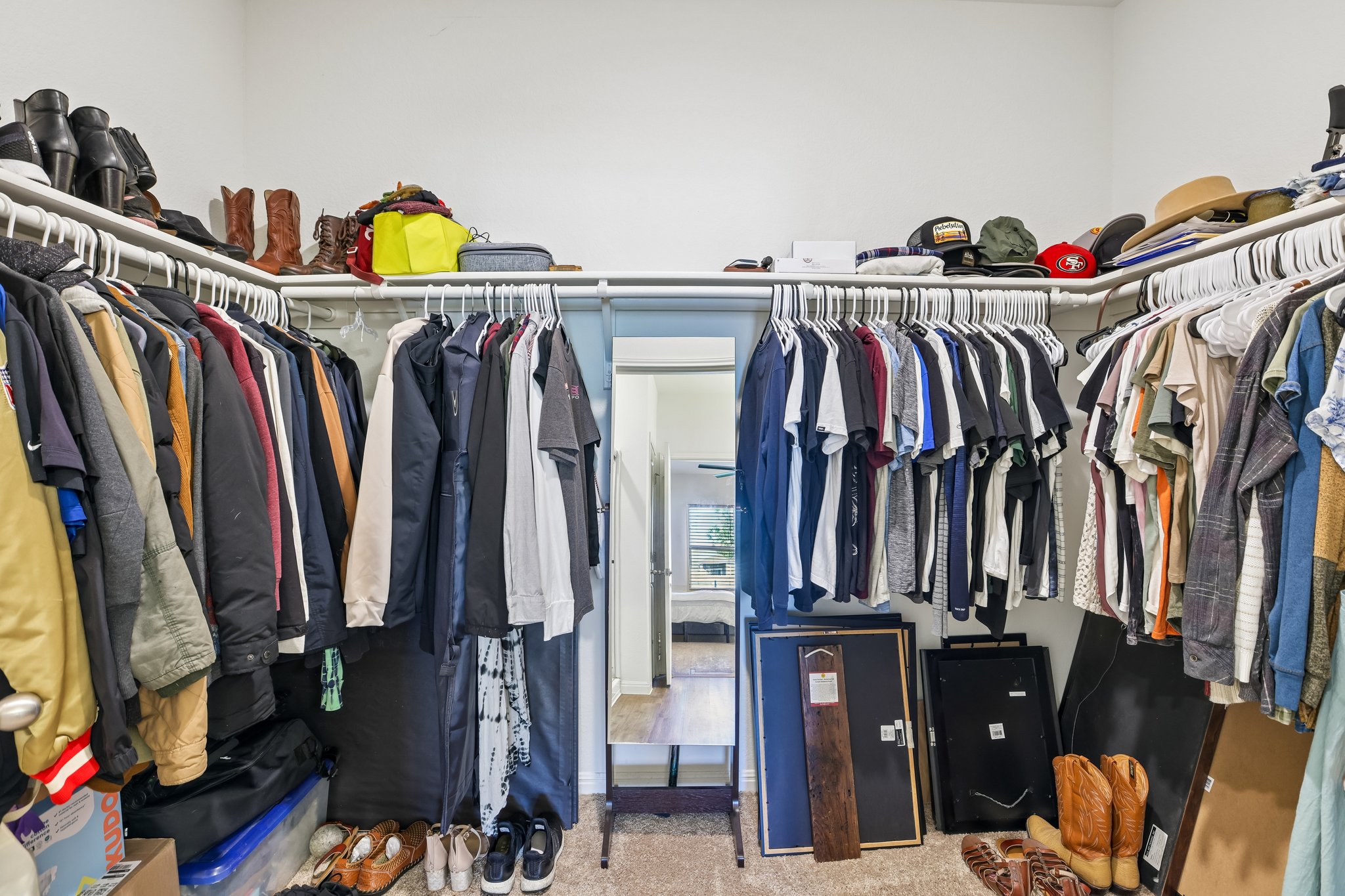 19105 Mike Mansfield Road Manor, TX 78653 - Photo 17 of 28 a view of walk in closet with clothes and shoes